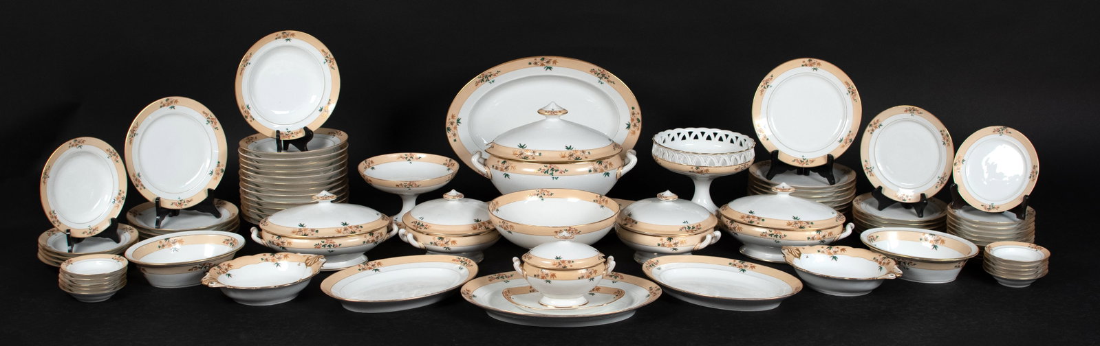 19TH C. OLD PARIS PORCELAIN SET.: A ca. 1850 Old Paris porcelain dinner service of eighty pieces, each with a wide apricot ground border painted with gilt and polychrome flowering branches within gilt banded rims, including: a two