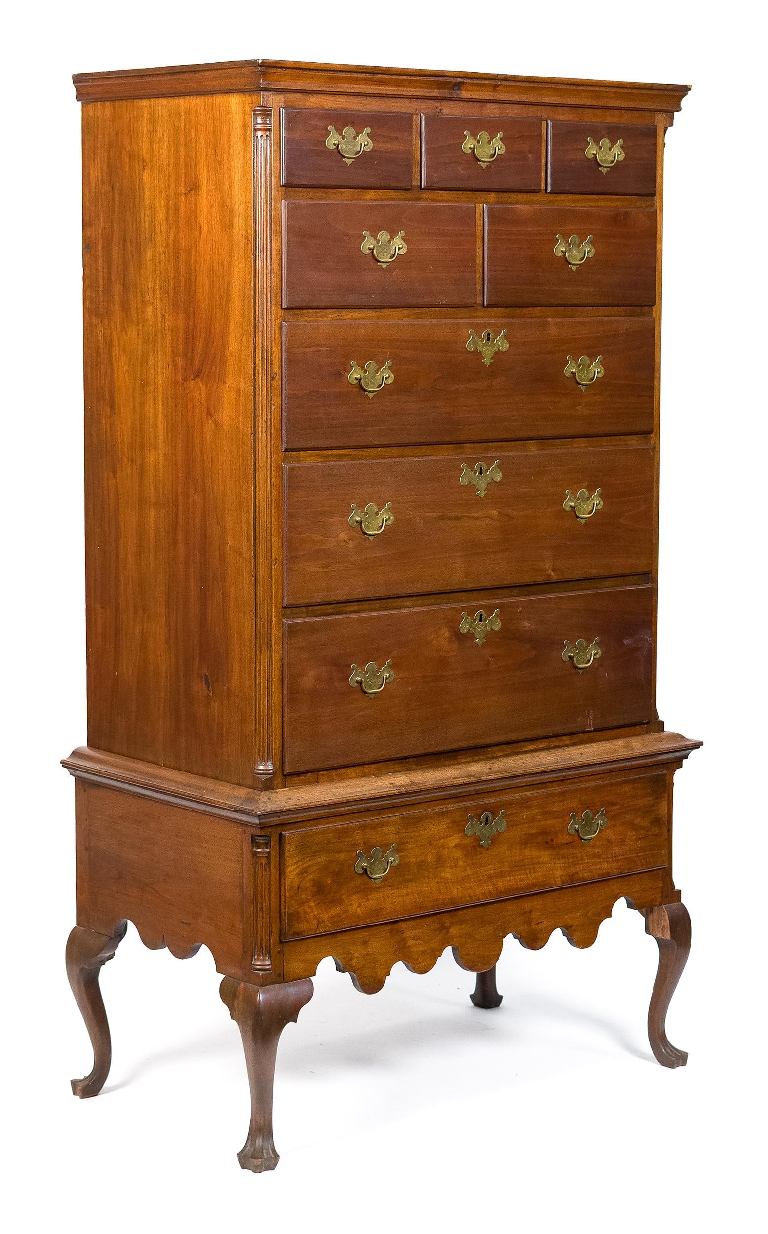 18TH C. PA WALNUT CHEST ON FRAME.: A ca. 1775 Pennsylvania walnut chest on frame. The top section sports three small drawers over two half-drawers over three graduated full-length drawers, flanked by fluted quarter columns. The bottom 