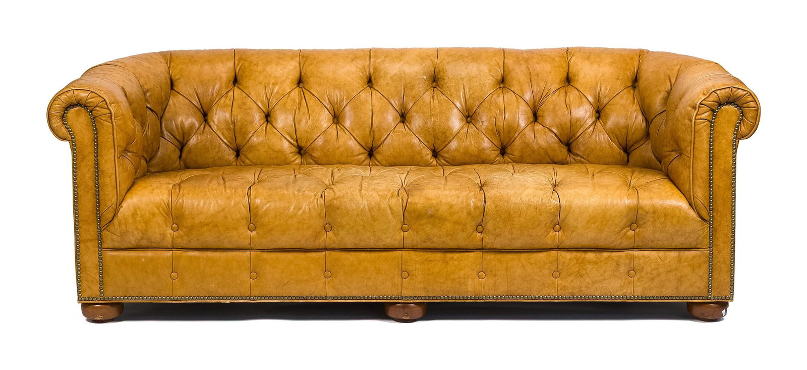 VINTAGE CHESTERFIELD LEATHER SOFA.: A fine quality vintage light brown Chesterfield leather sofa with tufted seat and back, on turned bun style feet. 28”H x 80”W x 36”D x 16” seat H.