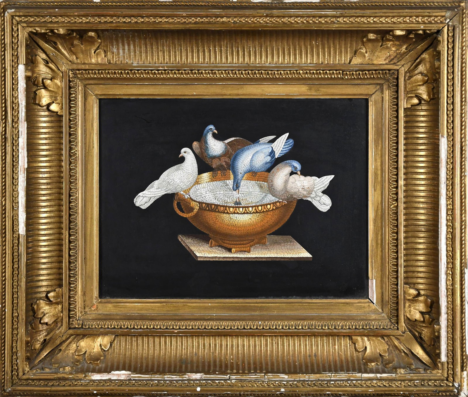 ANTIQUE ITALIAN MICROMOSAIC PLAQUE, CAPITOLINE DOVES.: A fine antique Italian micromosaic plaque depicting the Capitoline Doves, after the ancient Roman mosaic discovered at Hadrian’s Villa. Four doves perch on the rim of a gilt handled cup, one