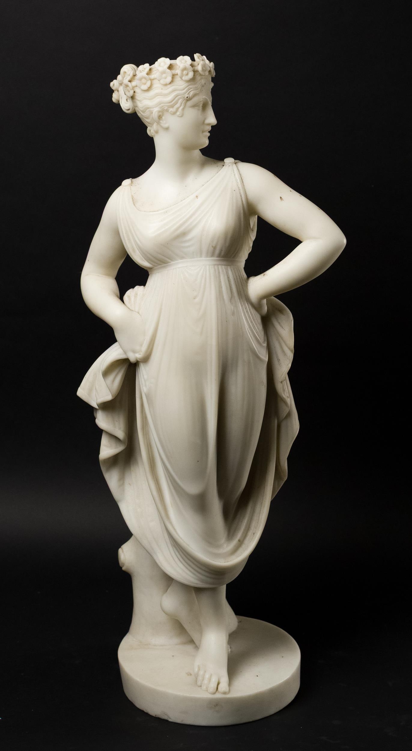 FINE 19TH C. ITALIAN CARVED MARBLE, VENUS.: A fine Italian 19th C. carved white marble figure of Venus. Modeled standing beside a tree trunk, wearing a flowing gown, her hair adorned with a wreath of flowers. Unsigned. 28”H.