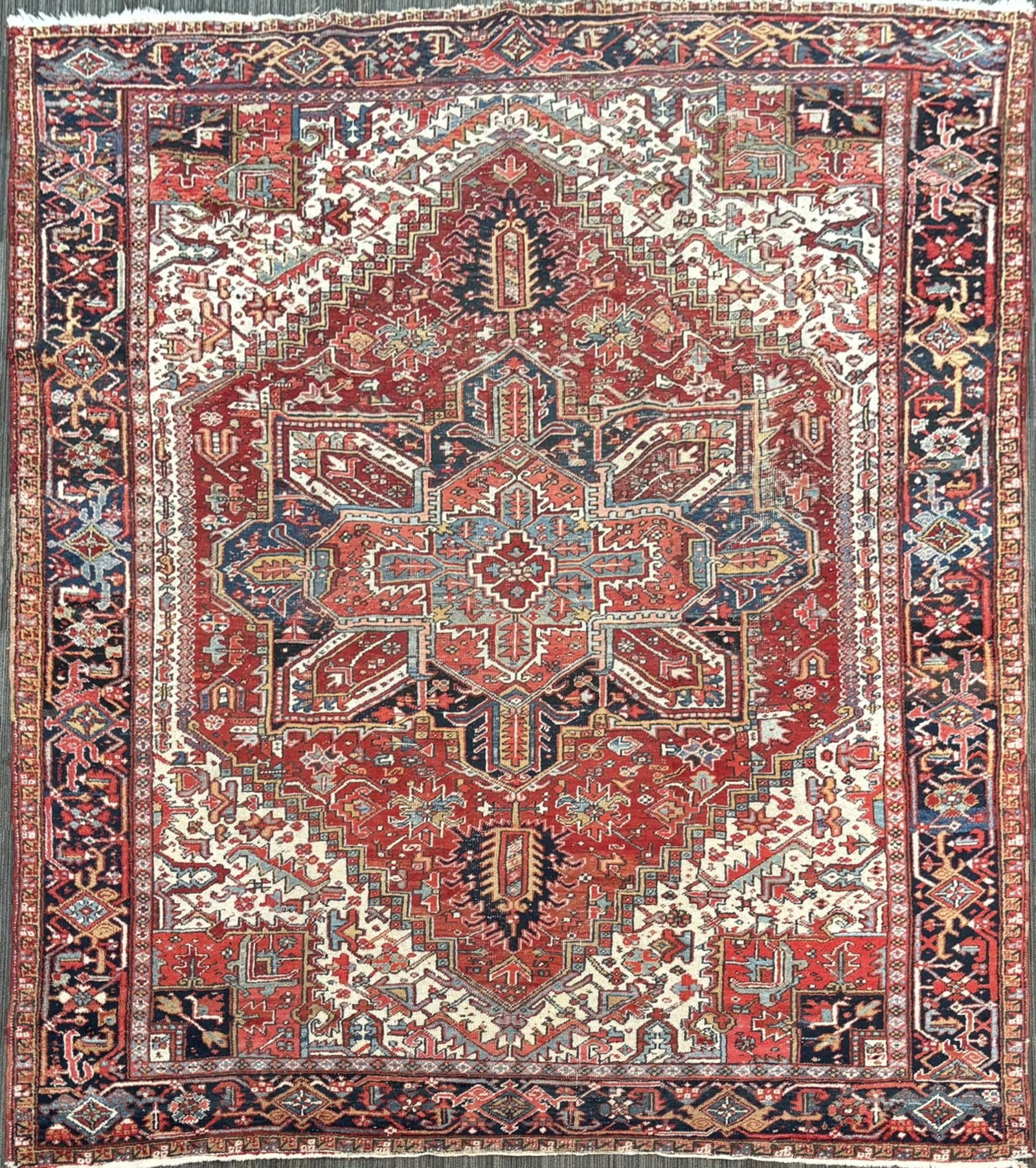 VINTAGE HERIZ ORIENTAL ROOM SIZE RUG.: A vintage Oriental Heriz room size rug with classic and desirable color palette and geometric design. 8’11” x 11’8”.
