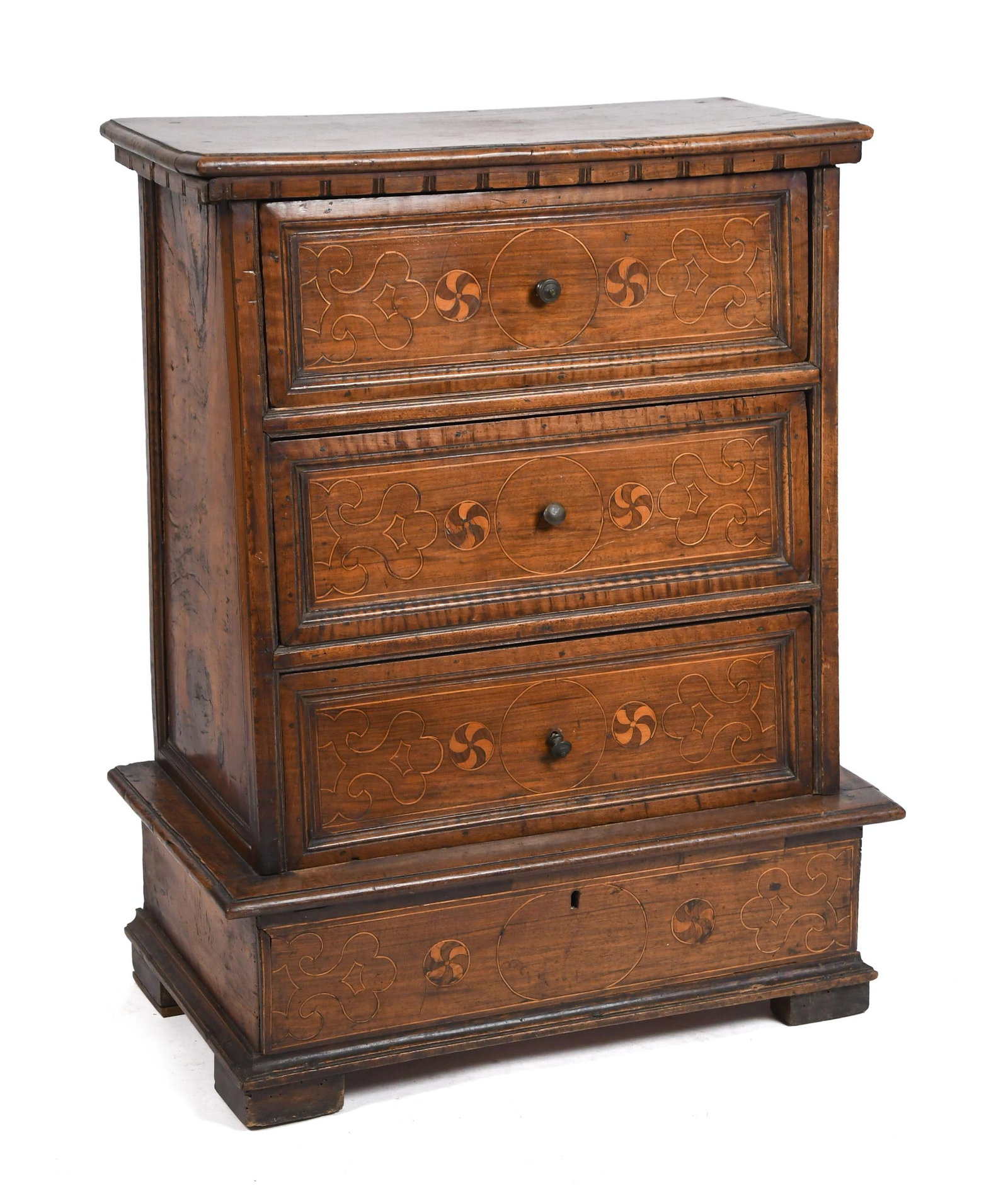 18TH C. ITALIAN WALNUT CHEST.: An early 18th C. Italian inlaid walnut canted four-drawer chest/cabinet. A molded top over three case drawers, each with scrolling line inlays and pin-wheels, over a concealed drawer in base. 35”
