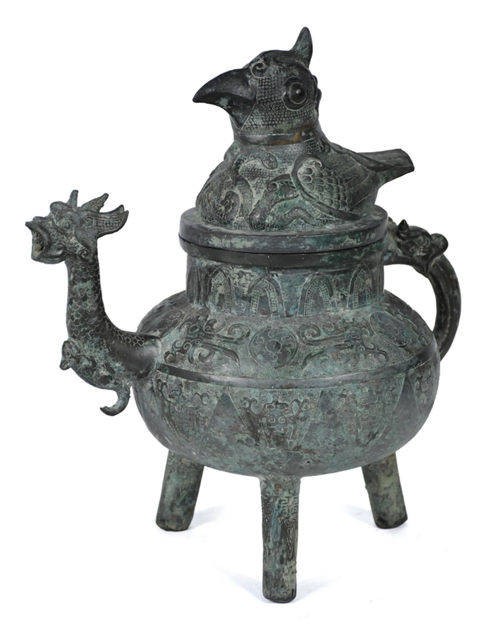 CHINESE ARCHAISTIC BRONZE TRIPOD VESSEL.: A Chinese archaistic style bronze tripod vessel in the archaic style, with an overall verdigris patina throughout. A phoenix-form finial lid with detailed feather and scale casting, a dragon-head