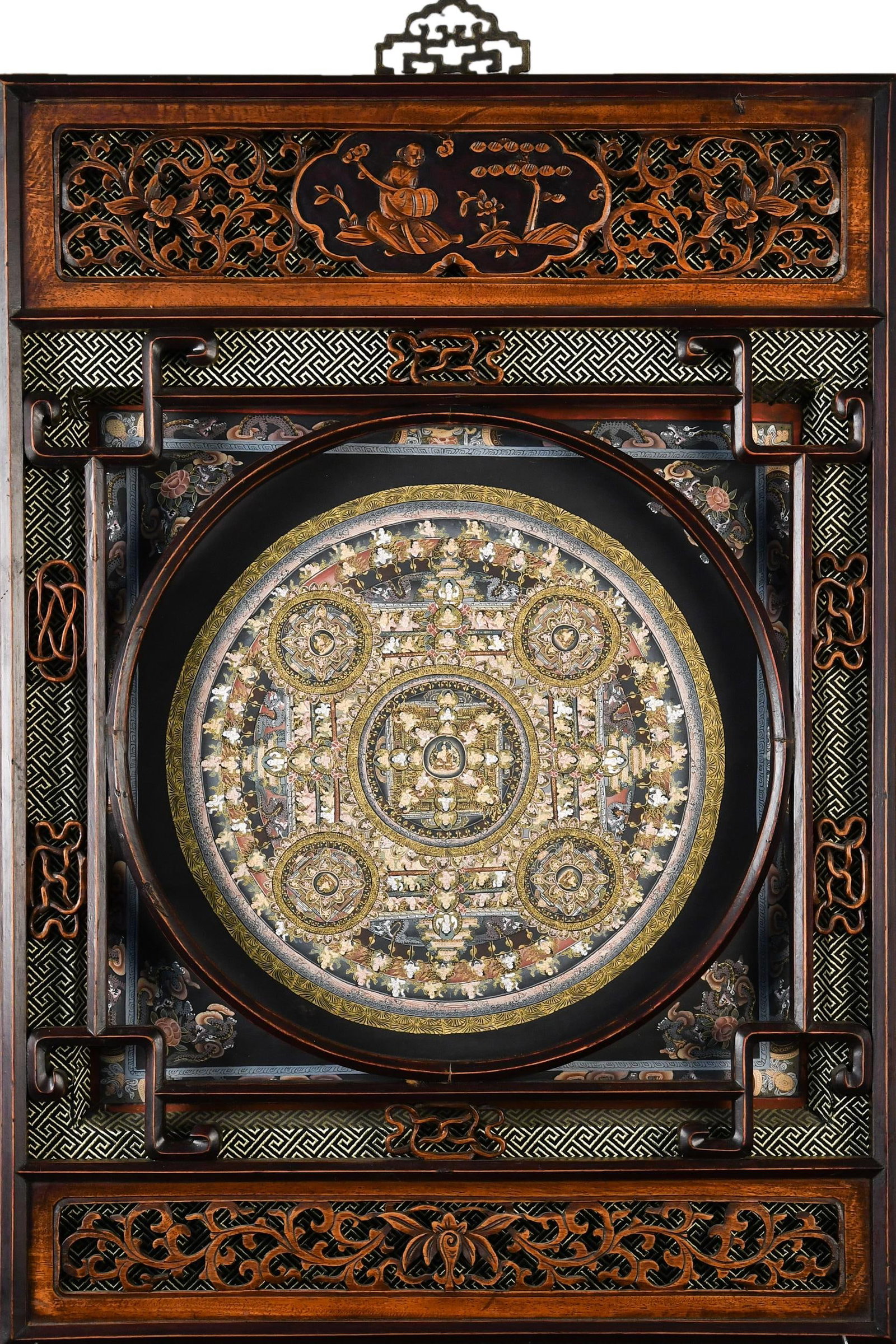ANTIQUE CHINESE PAINTED MANDALA.: Antique Buddhist mandala painting on fabric, depicting the Five Dhyani Buddhas within an intricate cosmological design. The fabric frame is mounted behind a carved Chinese hardwood frame featuring
