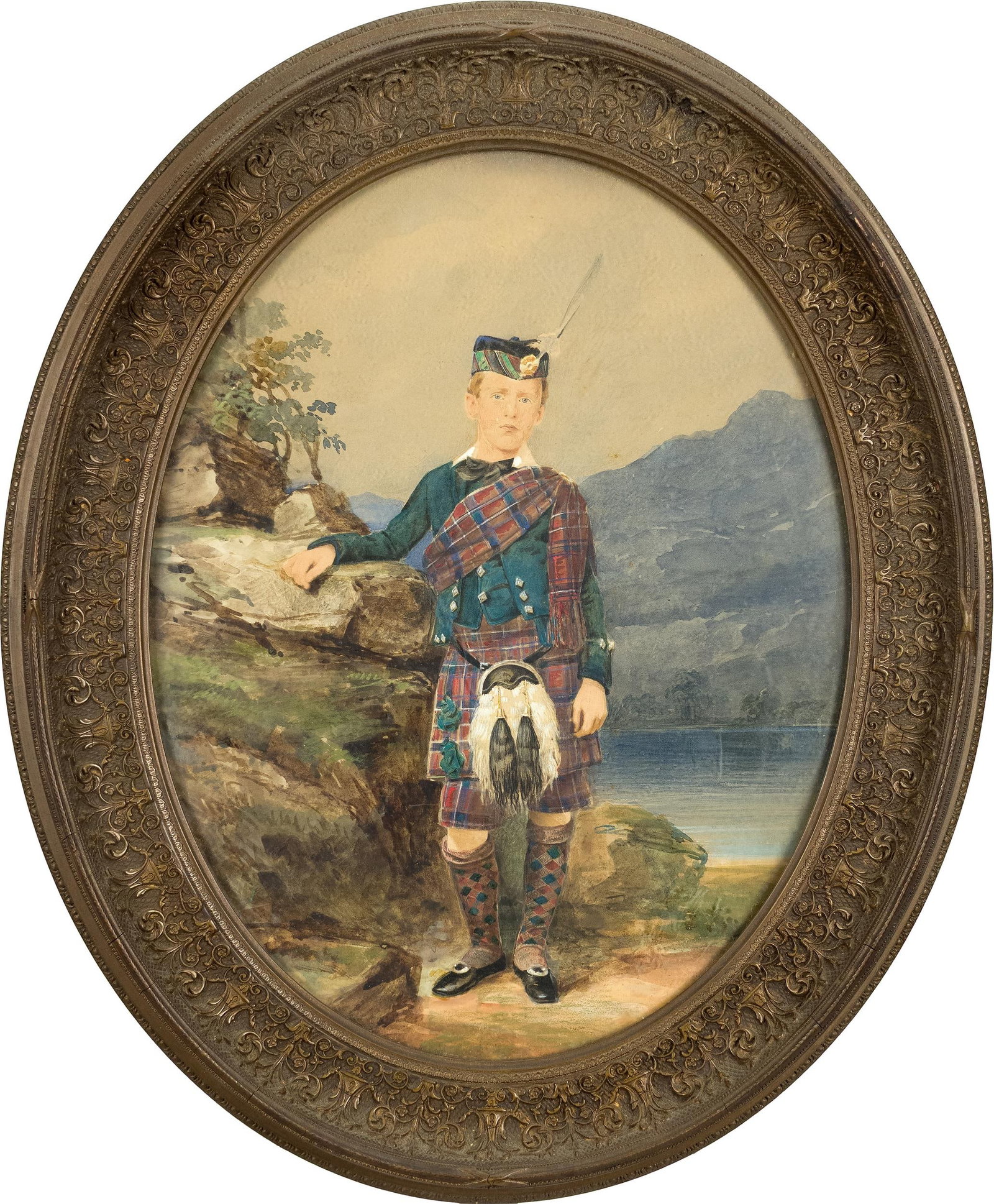 19TH C. SCOTTISH WATERCOLOR, PORTRAIT.: An antique oval Scottish watercolor, full-length portrait of a young boy dressed in traditional garb, posing amongst an iconic Scottish landscape, unsigned. Image 14” x 10”, Frame