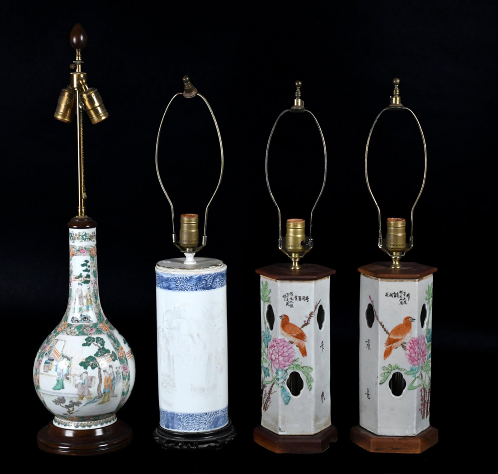FOUR ANTIQUE CHINESE PORCELAIN LAMPS.: Four 19th C. Chinese porcelain vessels, all converted to table lamps in the 20th century and mounted on turned wood bases, including: a pair of famille rose hexagonal hat stands, pierced at the should
