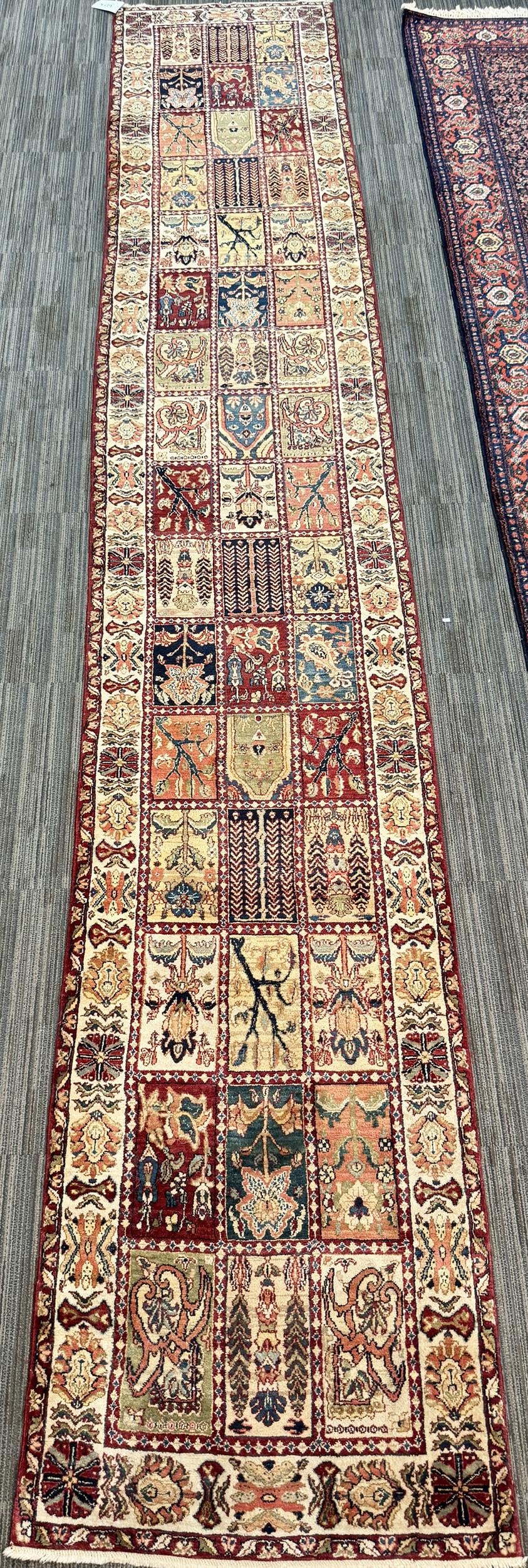 VINTAGE ORIENTAL WINDOW PANE RUNNER RUG.: A vintage Persian Bakhtiari garden-design runner, the field composed of ‘window panes’ depicting stylized flowering plants, trees, cypress forms and geometric motifs in rust, burgundy,