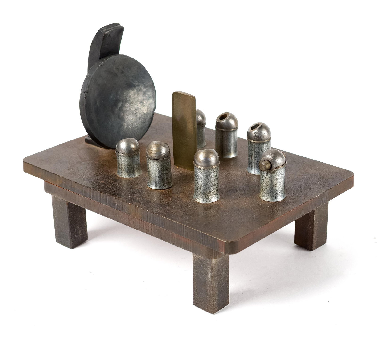 DONALD LOCKE SCULPTURE, BULLETS ON TARGET.: An iconic Donald Locke (1930-2010) mixed-media sculpture, featuring an assemblage of bullet-form cast metal elements and a brass rectangular tab arranged on a low rectangular steel platform raised on