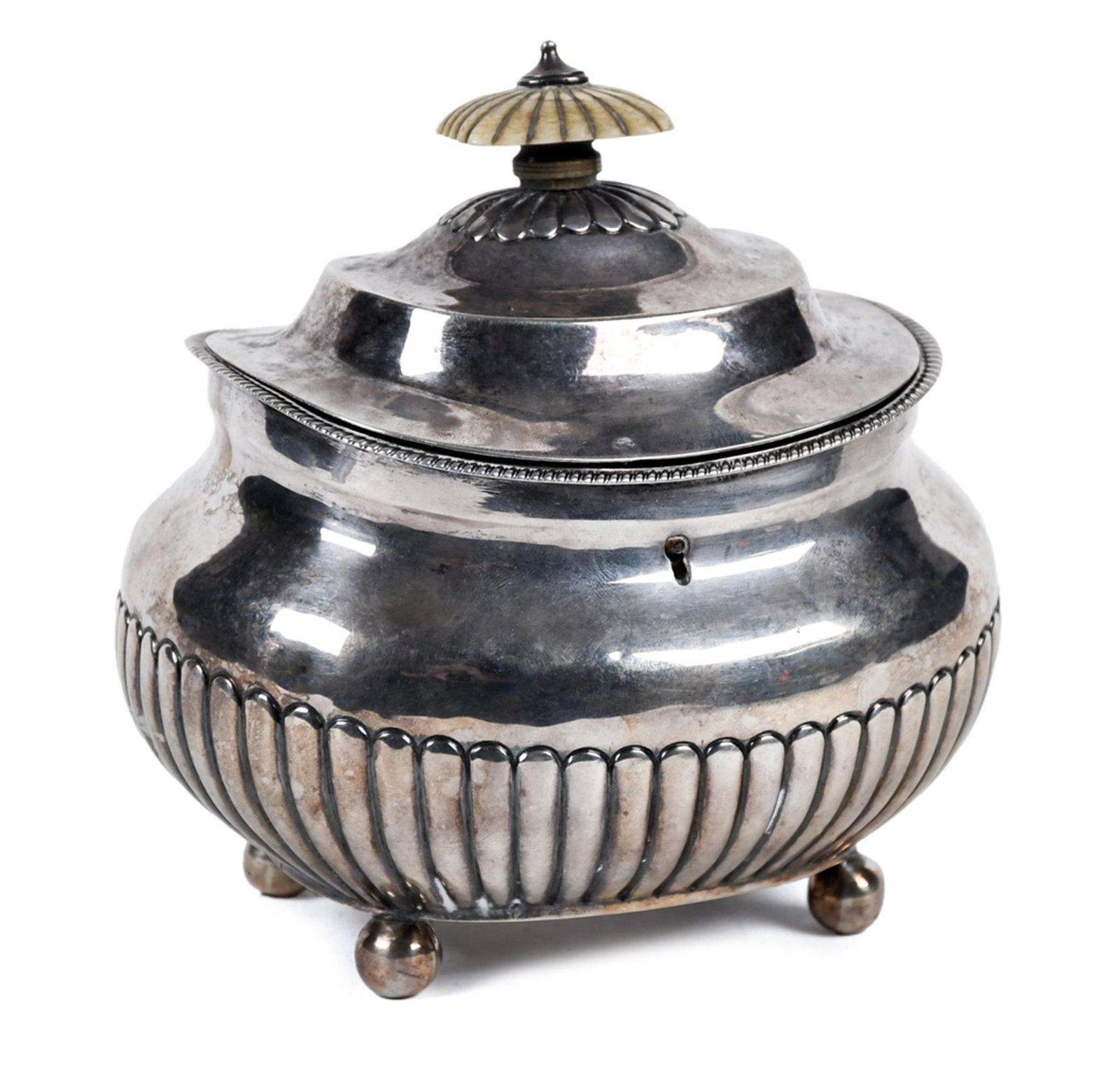 18TH C. GEORGIAN STERLING TEA CADDY.: An antique Georgian sterling silver tea caddy with a domed, gadroon-edged lid fitted with a lobed mushroom finial, the squat compressed body with vertical gadroon fluting to the lower half and a