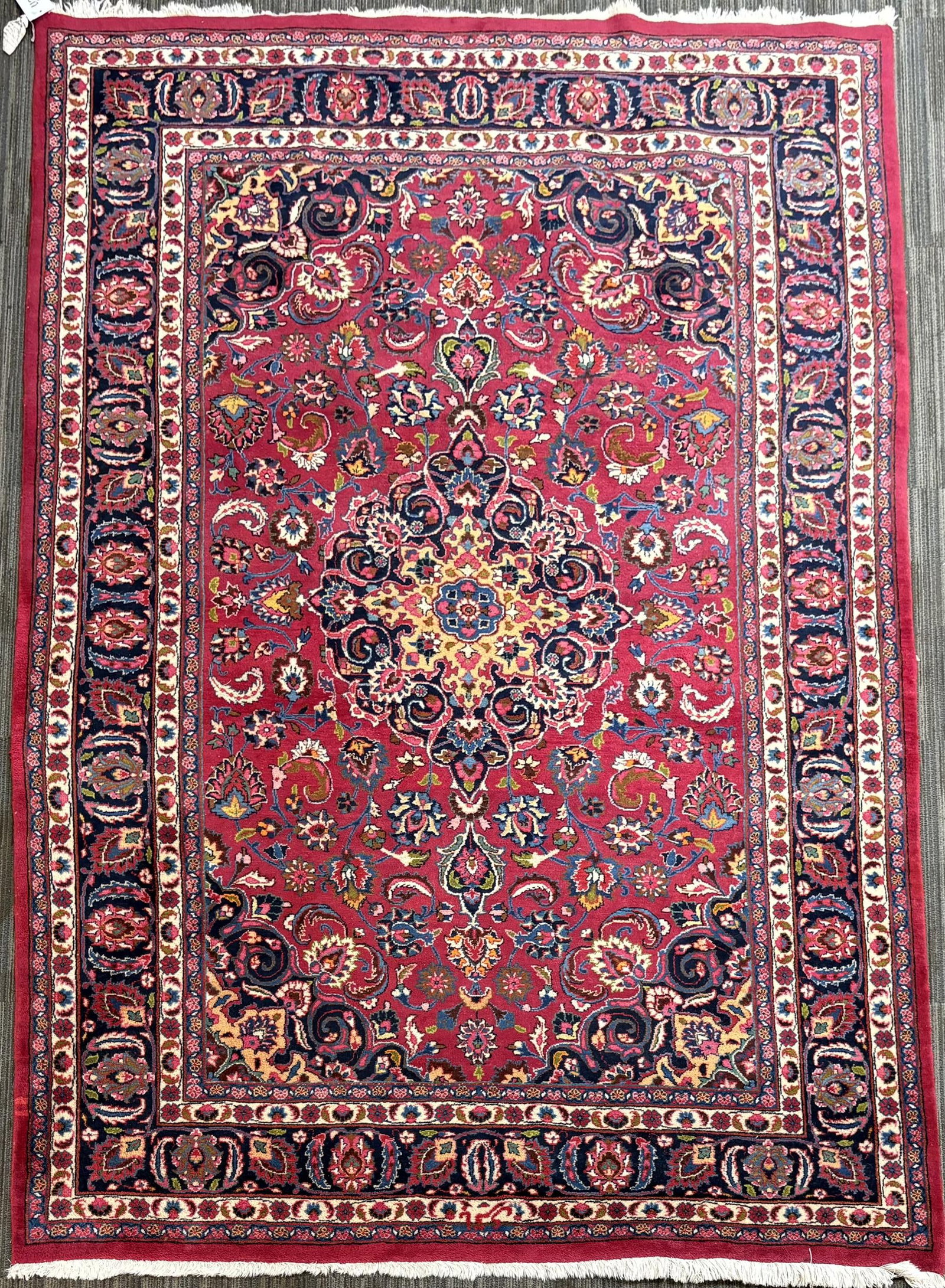 VINTAGE ORIENTAL ROOM SIZE RUG.: Vintage Oriental room size rug, with a rich maroon field centered by a floral medallion and densely decorated with scrolling vines, palmettes, rosettes and flowering sprays in navy, ivory, blue, green