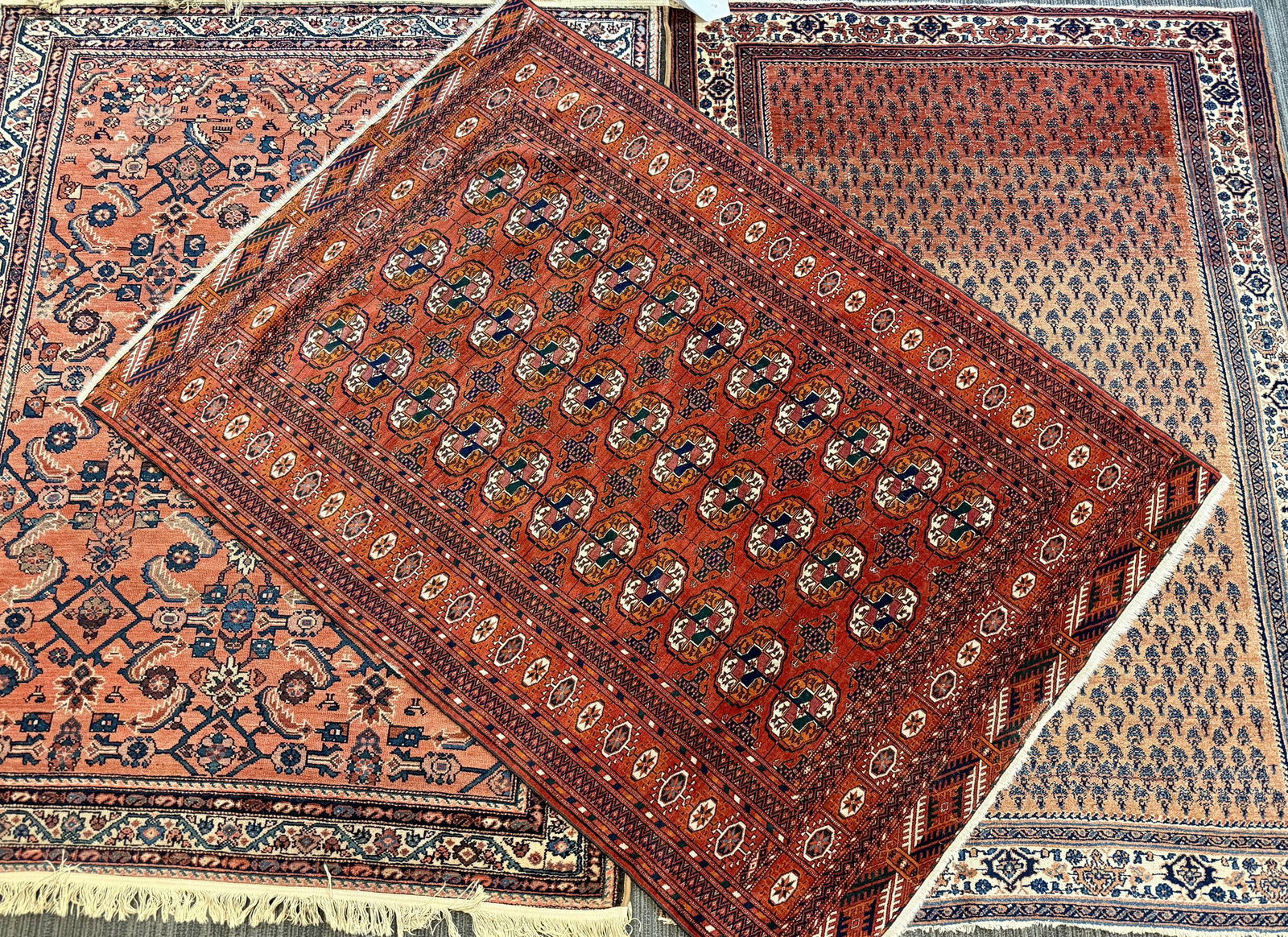 THREE ANTIQUE ORIENTAL SCATTER RUGS.: Three antique Oriental scatter rugs, including: a Turkoman Bokhara, the madder red field with three columns of octagonal guls divided by narrow bands, within multiple banded borders of octagons and st