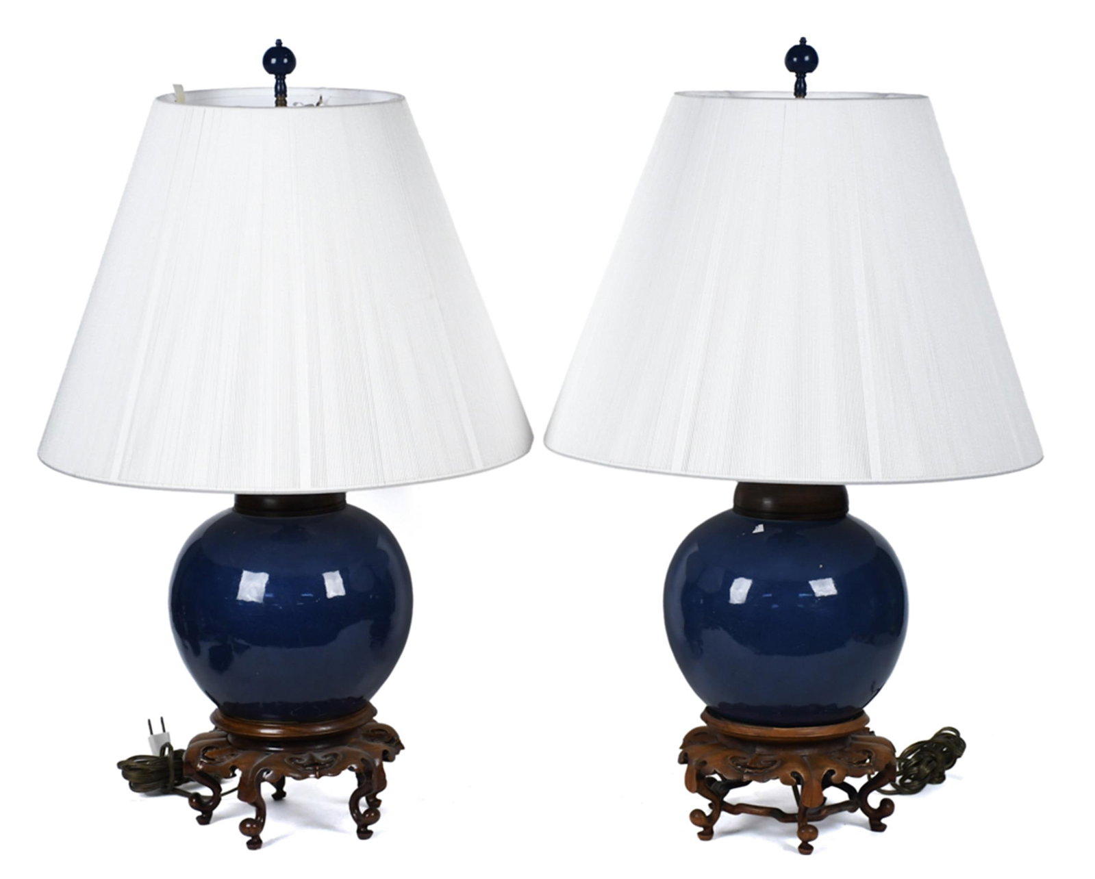 PR. ANTIQUE CHINESE BLUE GLAZED GINGER JAR LAMPS.: A pair of antique Chinese cobalt blue glazed porcelain ginger jar table lamps, each jar mounted on a carved wood reticulated base. Each spherical jar in a rich, high-gloss cobalt blue glaze, fitted wi