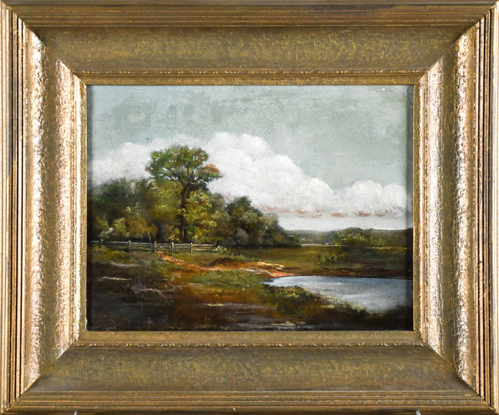 19TH C. OIL, LANDSCAPE WITH POND, BECKWITH.: A 19th C. oil on canvas depicting a tranquil landscape with a pond, split-rail fence, woodland, and distant rolling hills. Signed illegibly lower left, E. Beckwith. Similar to American Barbizon