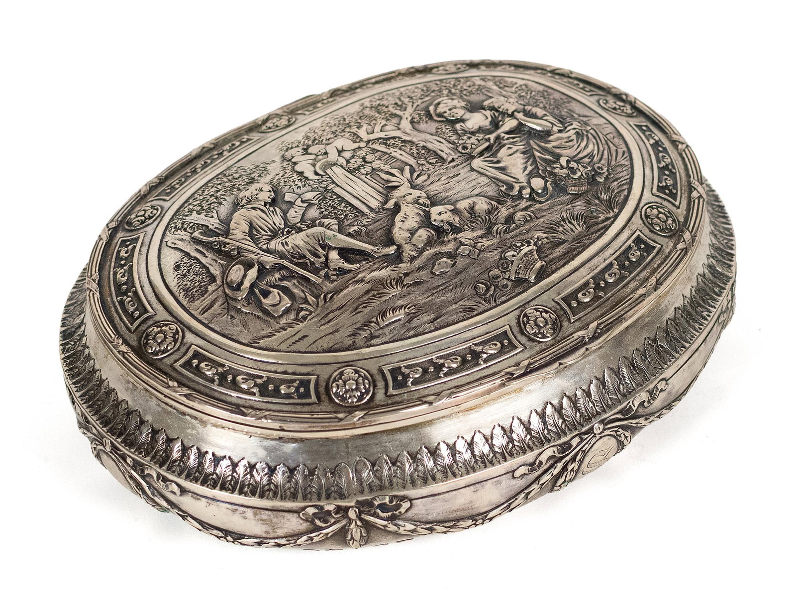 ANTIQUE CONTINENTAL SILVER BOX.: Antique continental silver box of oval form, the hinged cover finely repoussé decorated with a pastoral scene of seated figures, lambs and fountain with putti, enclosed by a decorative border of