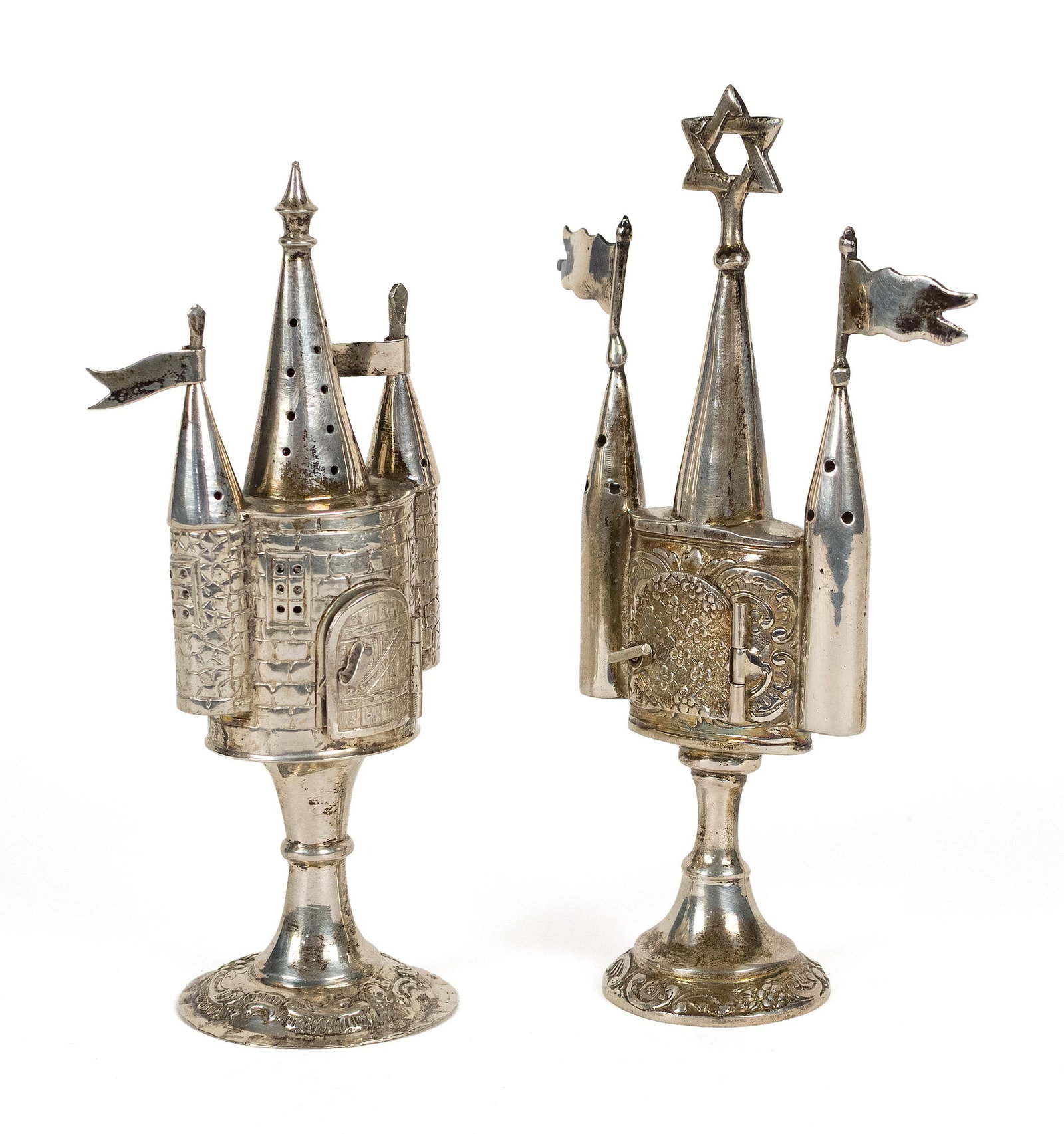 TWO ANTIQUE JUDAICA SILVER SMALL SPICE TOWERS.: Two antique Judaica silver (800 or similar purity) besamim, spice towers, each of architectural form. One with a central Star of David finial, the body with hinged compartment door; the other modeled