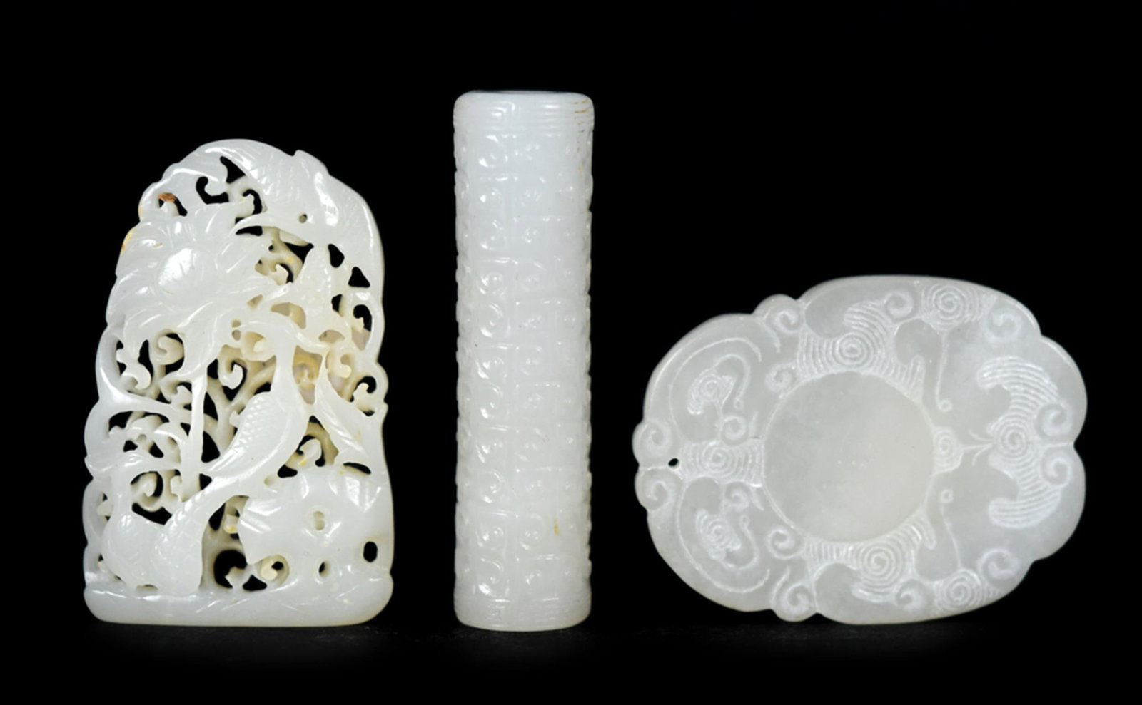 CARVED CHINESE WHITE JADE, 3PCS.: A collection of three antique white jade carvings in the neolithic and later Chinese styles, including:a cylindrical archaic-style carved tube with all-over incised geometric and thunder-scroll
