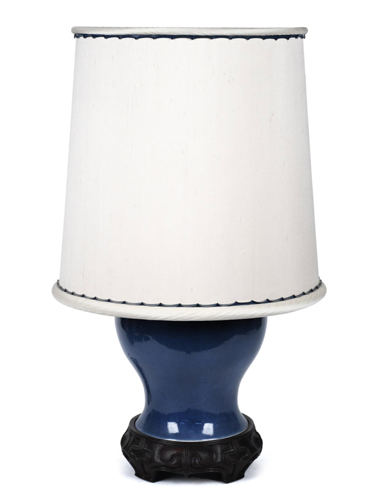 ANTIQUE CHINESE BLUE GROUND PORCELAIN TABLE LAMP.: An antique Chinese blue-glazed porcelain baluster-form vase with a double concentric ring mark on base, mounted as a table lamp on a carved hardwood base with key-fret border, fitted with a