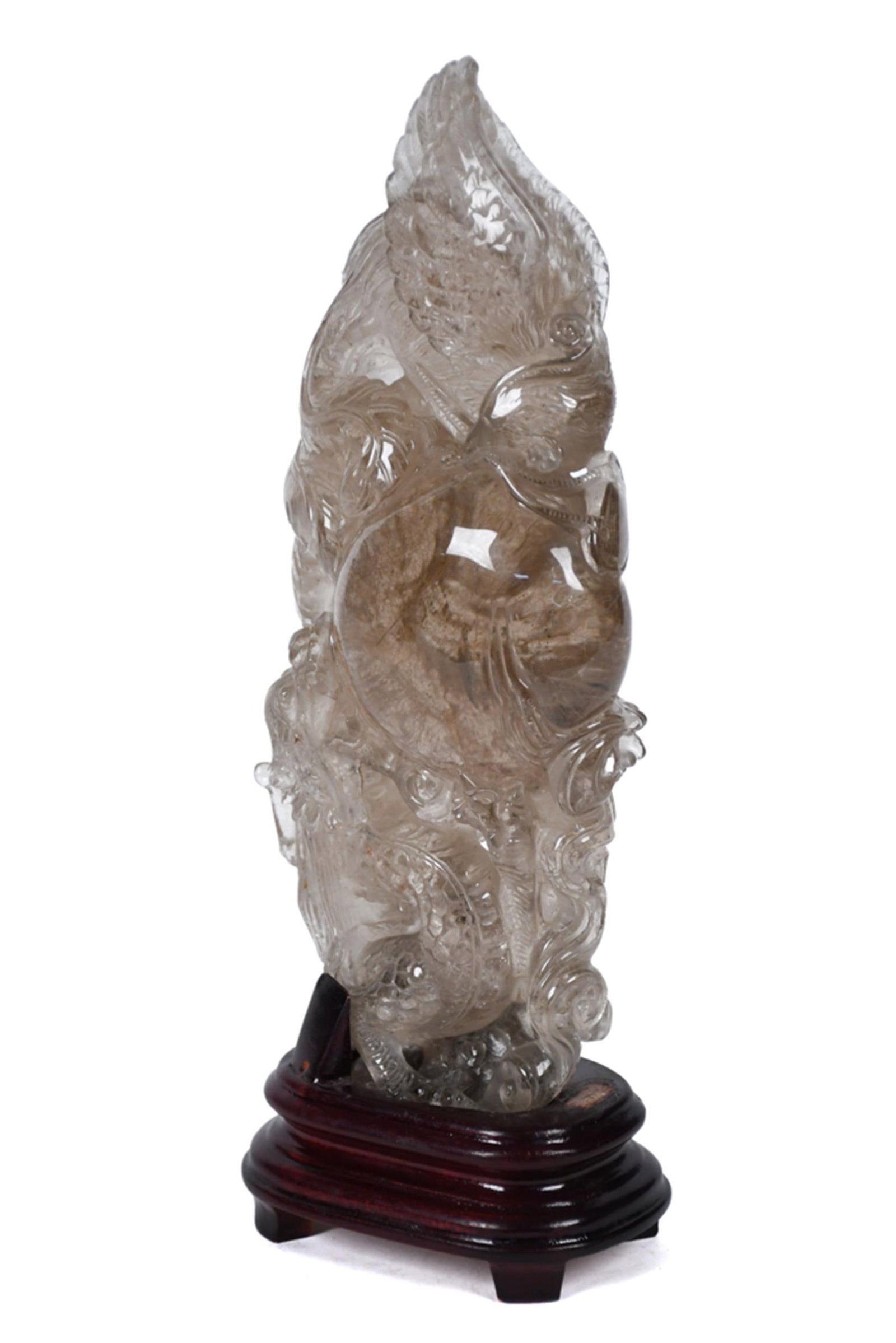 ANTIQUE CHINESE CARVED ROCK CRYSTAL DRAGON & PHOENIX.: An antique Chinese carved rock crystal figure depicting intertwined dragon and phoenix motifs, with deeply worked feather and scale detail throughout and natural smoky inclusions in the lower body.
