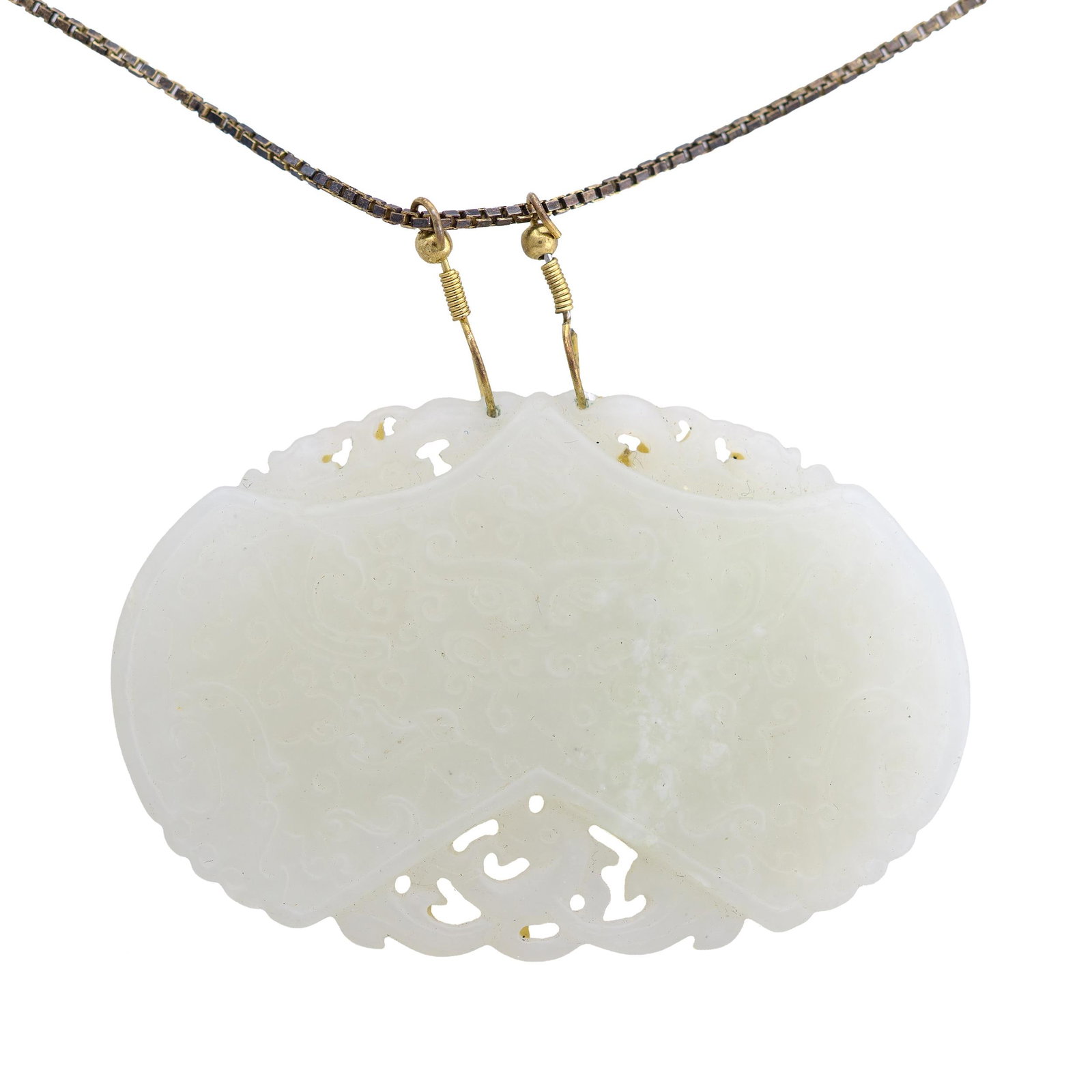 ANTIQUE WHITE JADE CARVED TAOTIE PENDANT NECKLACE.: An antique white jade pendant of oval plaque form, suspended from a gold-tone chain and clasp. Deeply carved in low and openwork relief with a central taotie mask amid dense archaistic scrollwork,