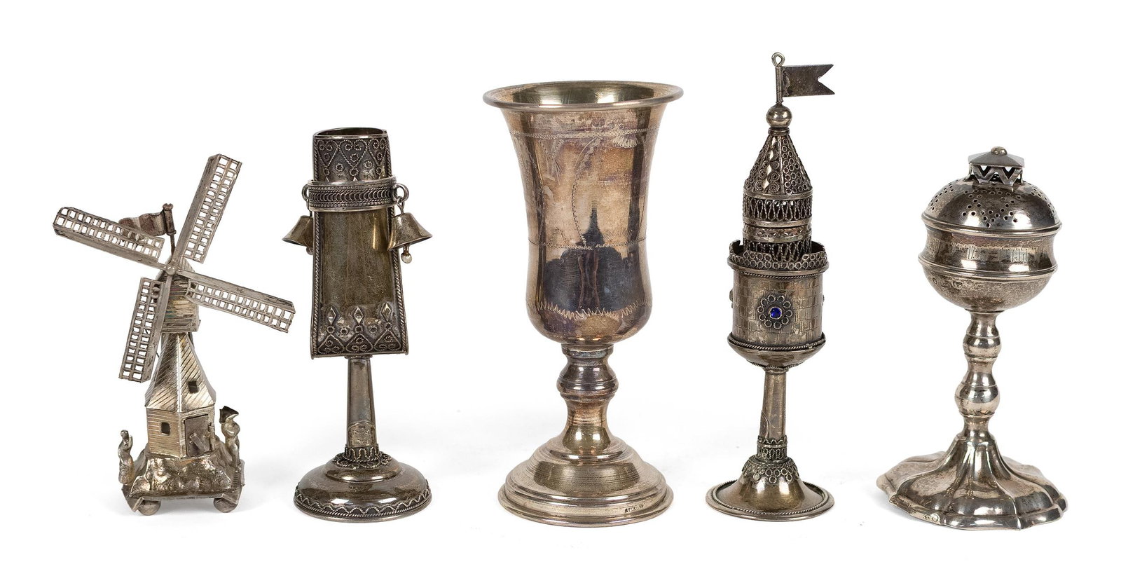 FIVE SMALL SILVER JUDAICA RITUAL OBJECTS.: A group of five silver Judaica ritual objects, including three small spice towers, one in the form of a windmill 4.5”H; a tower turret form with inset blue gems 5.75”H; and other with roun