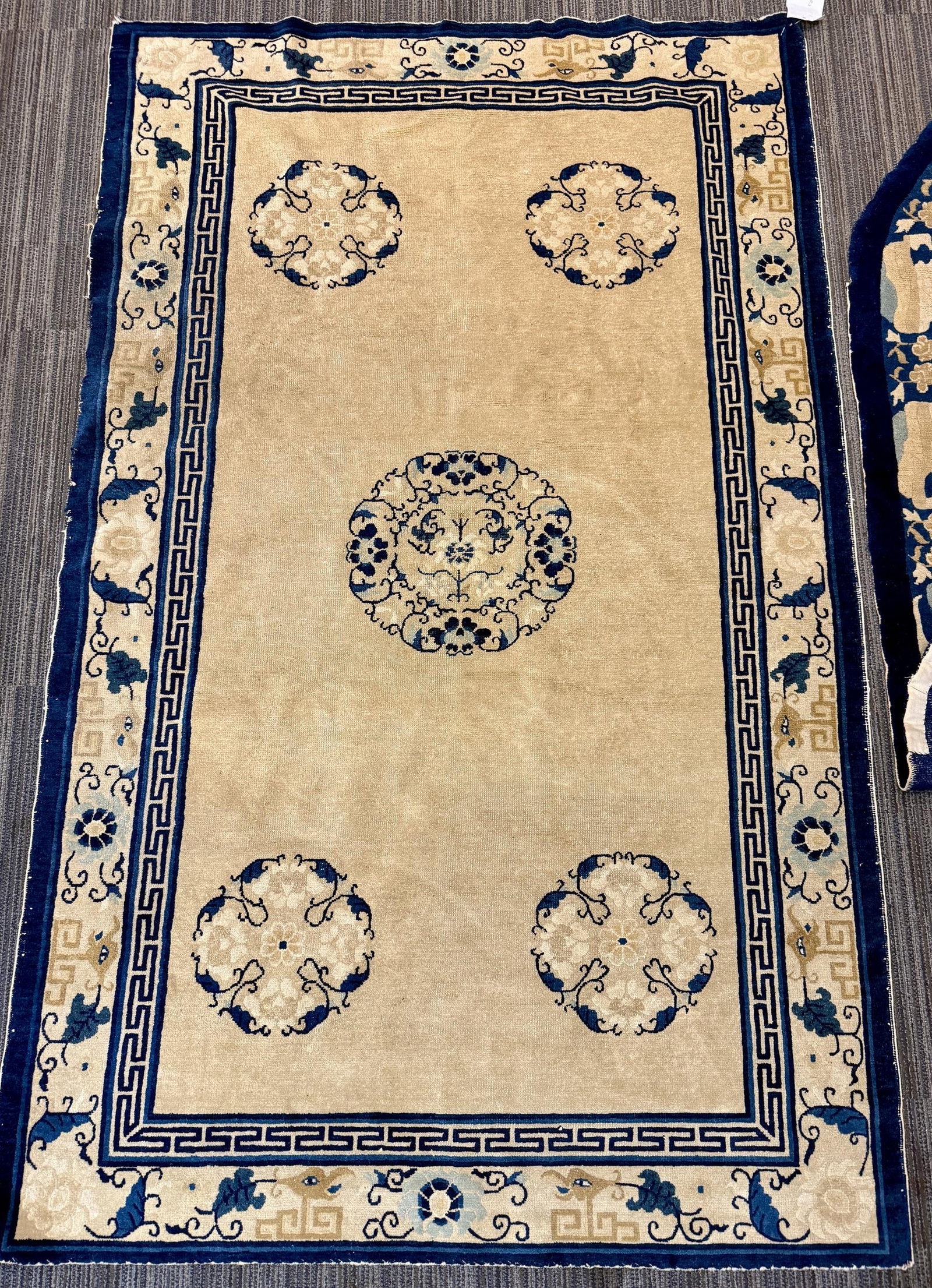 TWO ANTIQUE CHINESE SCATTER RUGS.: Two antique Chinese carpets, including: a rectangular carpet, the tan field centering a circular floral medallion within four smaller floral roundels at the corners, enclosed by a Greek key band and a