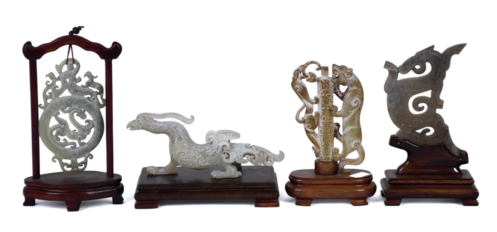 FOUR CHINESE CARVED JADE MYTHICAL FIGURES. (1 of 1)