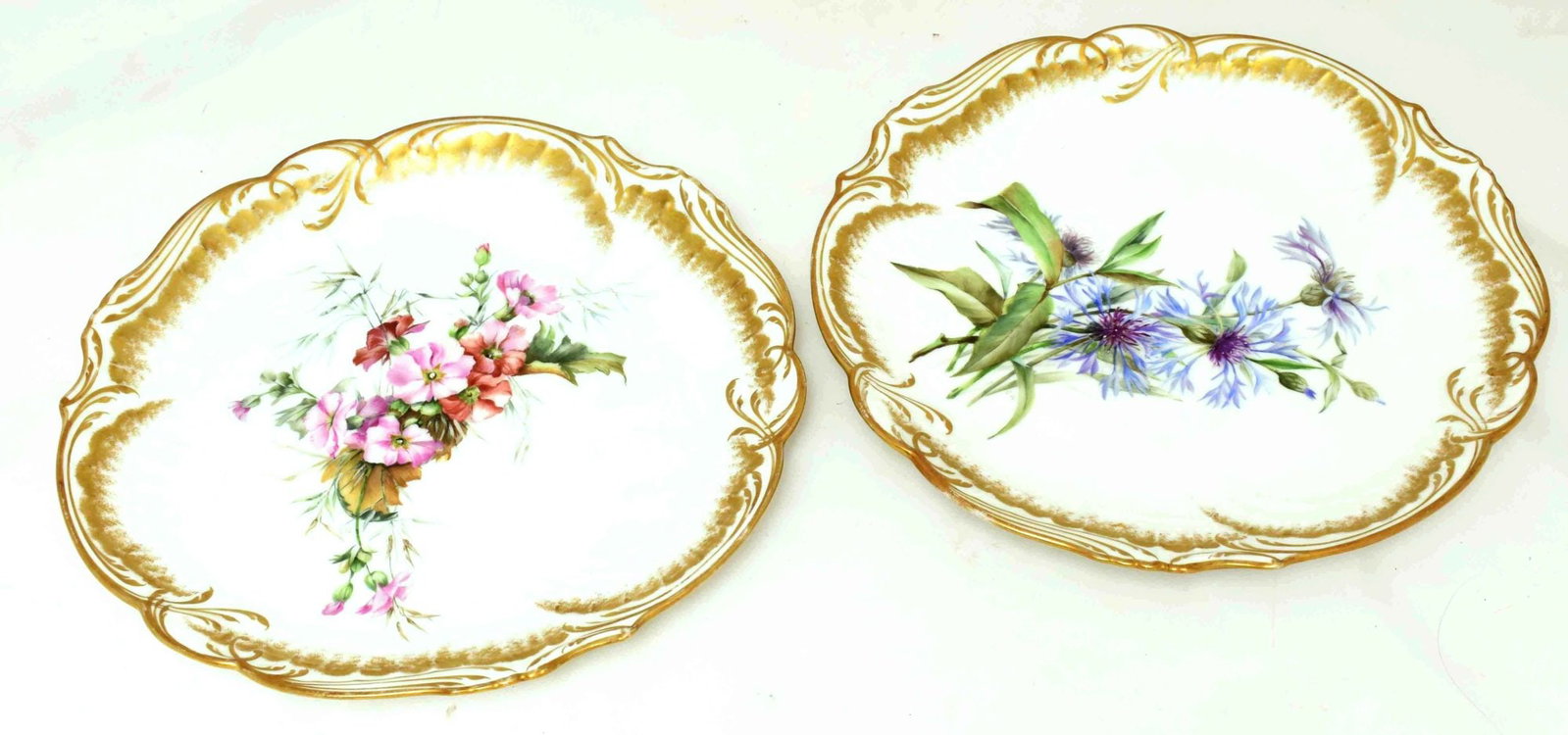 Set of 2 plates with floral ornament. - France, 20th century. - Diameter: 23 cm. (1 of 2)