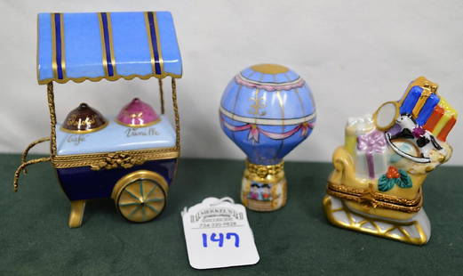 Limoges France Boxes Lot of 3: Balloon, Sleigh, & Cart: This Limoges France porcelain lot includes 3 boxes: La Pastelle Blue Hot Air Ballon #5/500 and the base is marked CM PEINT MAIN Limoges France 5/500. Christmas sleigh full of toys & presents, the