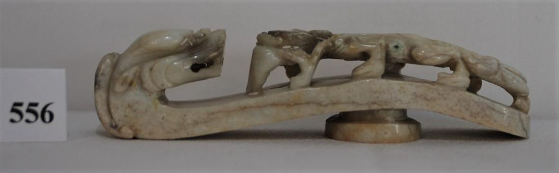 Antique 18th Century Chinese Chicken-Bone Jade Belt: "This well carved antique Chinese Â“chicken-boneÂ” jade belt buckle has a dragon head terminal and openwork chilong biting a branch. There are some small flaws. The length is 3 7/8 inches x 7/8"