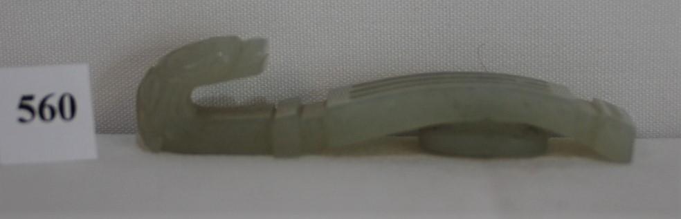 Antique White Jade Buckle from the Chien Lung period: This imperial jade is white and from the Ching Dynasty of the Chien Lung period 1736-1796. The buckle has a dragon head, carving on handle suggests columns. Length is 2 1/2" x 1/2" x 3.4" inches. JADE