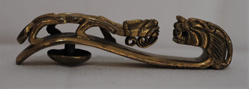 Antique Chinese Gilt Bronze Belt from the Chien Lung: This bronze buckle has a dragon head and dragon carved on top. This buckle is from the Ching Dynasty of the Chien Lung period 1736-1796. Length is 2.75 x 5/8" x 5/8" inches. Weight is 40.28 grams. Thi