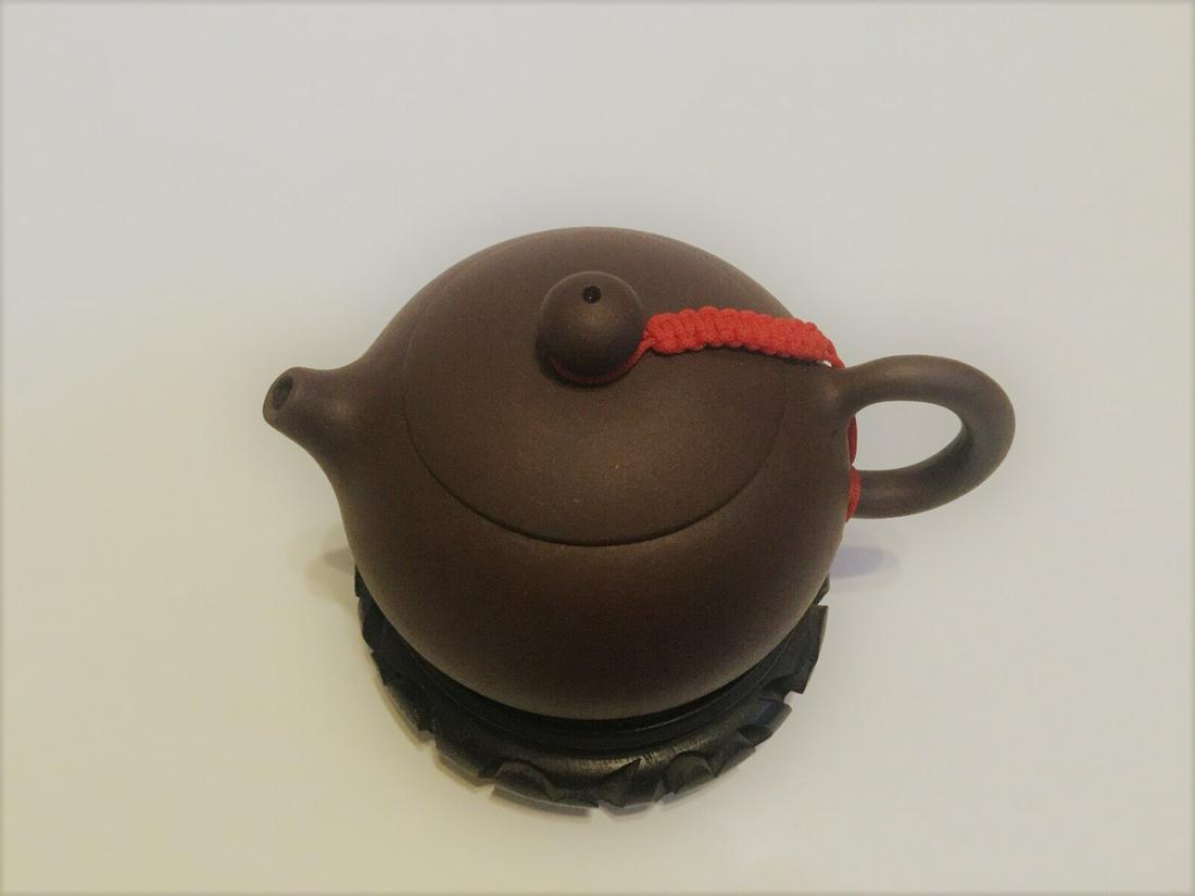 Chinese Yixing purple clay teapot with sigh: MEASURES width:13cm,high:7.5cm wooden base not included