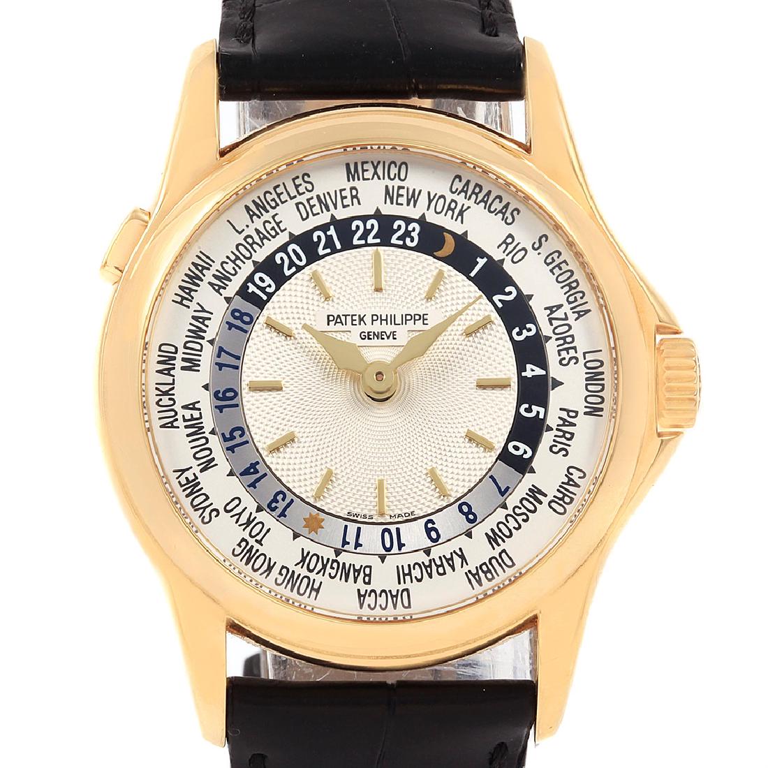 Patek Philippe World Time Complications: 18k yellow gold case 37 mm in diameter. Crown with protective shoulders, pusher at 10 o'clock to change cities, screw-down sapphire crystal exhibition case back. 18k yellow gold smooth bezel. Black le