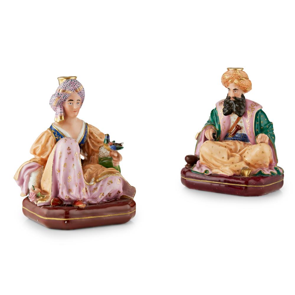 PAIR OF JACOB PETIT PORCELAIN FIGURAL INCENSE HOLDERS: FRENCH FOR THE TURKISH MARKET, 19TH CENTURY modelled as a seated sultan with a hookah pipe and sultana with a bird, with openings in their turbans, in polychrome costumes on puce canted bases, with ma