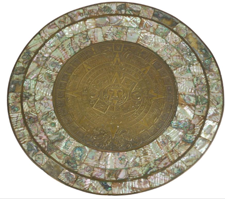 AN ANTIQUE BRASS AND MOTHER OF PEARL INDO PORTUGUESE CIRCULAR CHARGER: Description: AN ANTIQUE BRASS AND MOTHER OF PEARL INDO PORTUGUESE CIRCULAR CHARGER Centrally decorated with facial mask surrounded by cartouches and symbols. Size: diameter 39cm