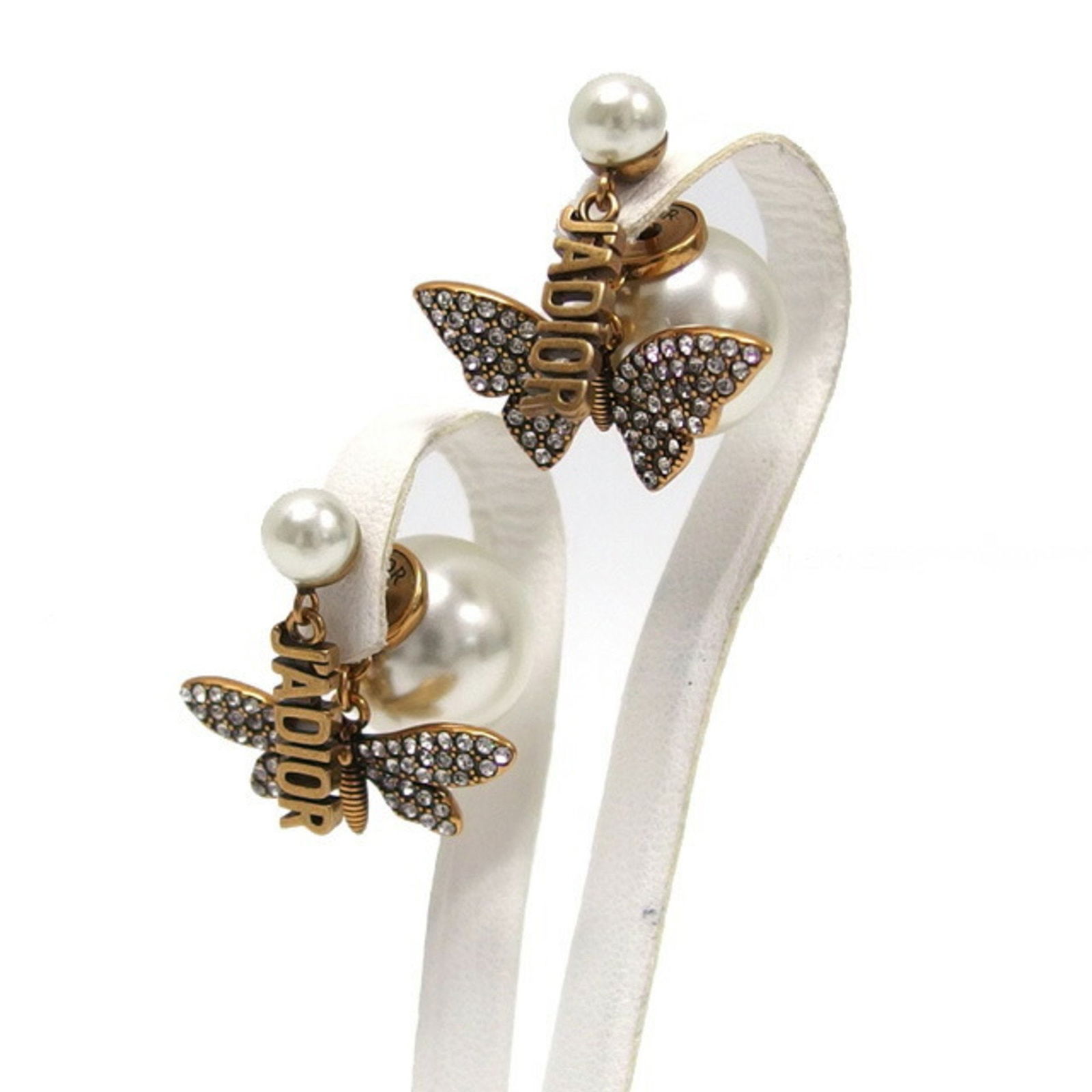 CHRISTIAN DIOR SWING BUTTERFLY EARRINGS: Christian Dior Swing Butterfly Earrings Brand: Christian Dior Type: Stud earrings Material: Metal Color: White Size: 24.00mm x 23.00mm / 0.94'' x 0.91'' Accessories: None Accessories Not