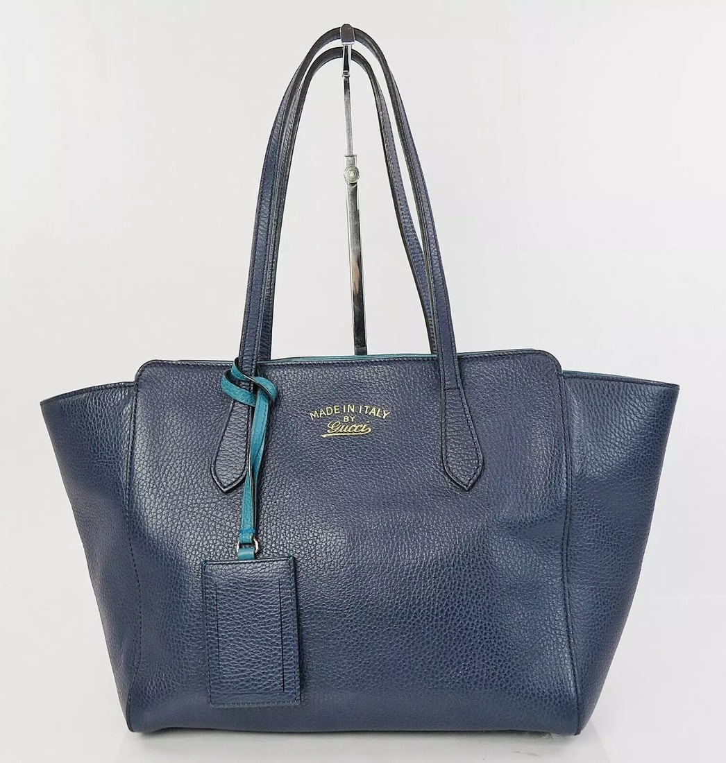 GUCCI BLUE LEATHER SWING LADY TOTE BAG: GUCCI Blue Leather Swing Lady Tote Bag Brand: Gucci Type: StyleTote Material: Leather Color: Blue Size: W 10.2 (bottom) x H 9.1 x D 5.1inch Accessories: None Accessories Notice: When purc
