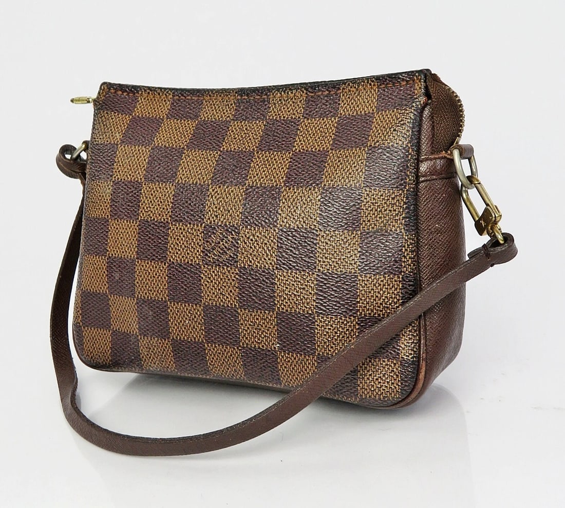 LOUIS VUITTON TROUSSE DAMIER EBENE COSMETICS POUCH BAG: LOUIS VUITTON Trousse Damier Ebene Cosmetics Pouch Bag Brand: Louis Vuitton Type: Cosmetic Bags Material: Coated Canvas Color: Brown Size: Size in inches (approx.):W 6.3 x H 5.1 x D 1.9Handle drop