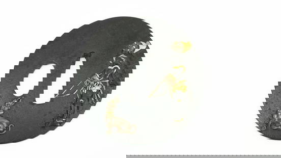 IRON TSUBA (MGJ273): Iron Tsuba (MGJ273) Description: Iron Tsuba. Namban figure of a foreign hunter with bow and arrow. Dog in Sentoku on point. Both figures highlighted in gold.  Size: Length 2.75 inches  Accessories: No