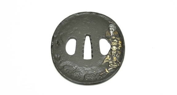IRON TSUBA (MGJ209): Iron Tsuba (MGJ209) Description: Iron Tsuba. Old figure with ornate robe standing on sword below figure. On the reverse are waves with gold and silver.  Size: Length 3–3&frac12; inches  Accessories: