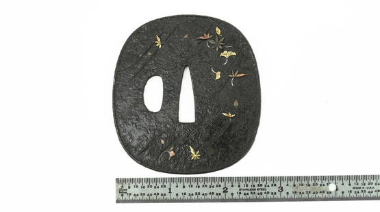 IRON TSUBA (MGJ306): Iron Tsuba (MGJ306) Description: Iron Tsuba. Motif of falling leaves with gold and copper highlights. Nice patina.  Size: Length 2.5 inch  Accessories: None Accessories Notice: When purchasing pre-own