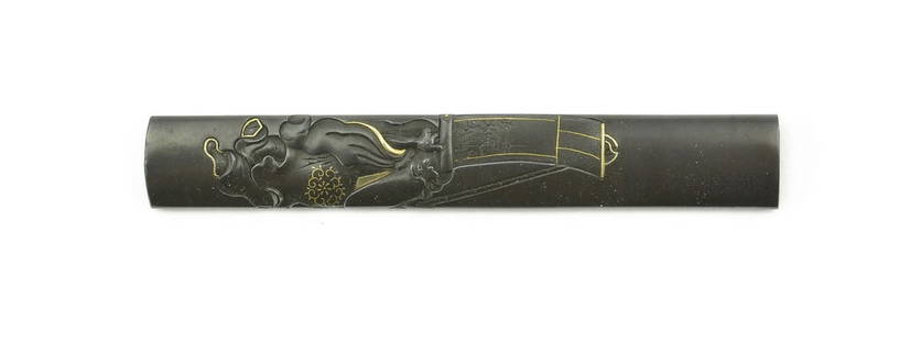 KINKO KODZUKA: Kinko Kodzuka Description: Kinko Kodzuka. Polished shakudo ground. Robed figure with scroll. Gold highlights. Boxed with N.B.T.H.K. certificate from 1971. Signed: Morikawa Masa Haru. Ref. Baur, P. 382
