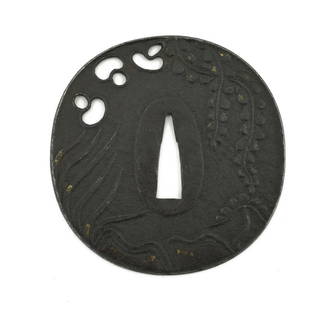 IRON TSUBA: Iron Tsuba Description: Iron Tsuba. Round or Mara Gata. Raised rim. Foliage and waves. Unsigned. Katana size. Vertical height 3 &frac12;&rdquo; (8.7 cm).  Size: Vertical height 3 &frac12;&rdquo; (8.7