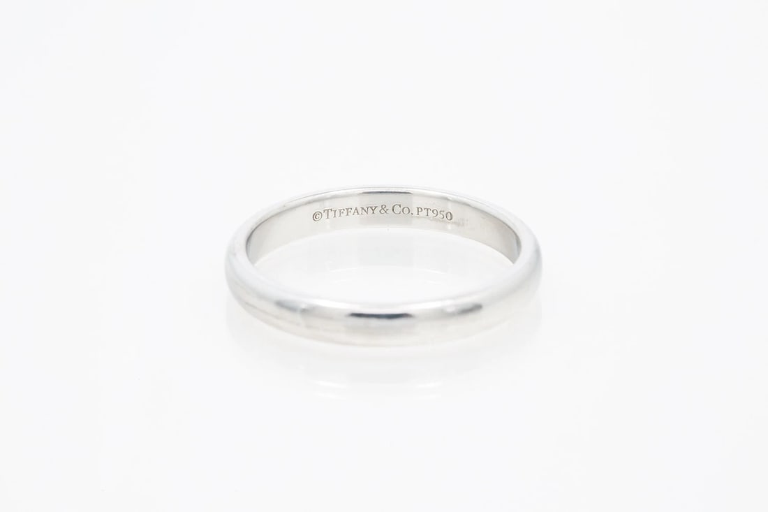 TIFFANY & CO CLASSIC PLATINUM DOMED WEDDING BAND RING: Tiffany & Co Classic Platinum Domed Wedding Band Ring Brand: Tiffany & Co Type: Ring Material: White Color: Platinum 950 Size: 7.25 US Accessories: None Accessories Notice: When purchasing