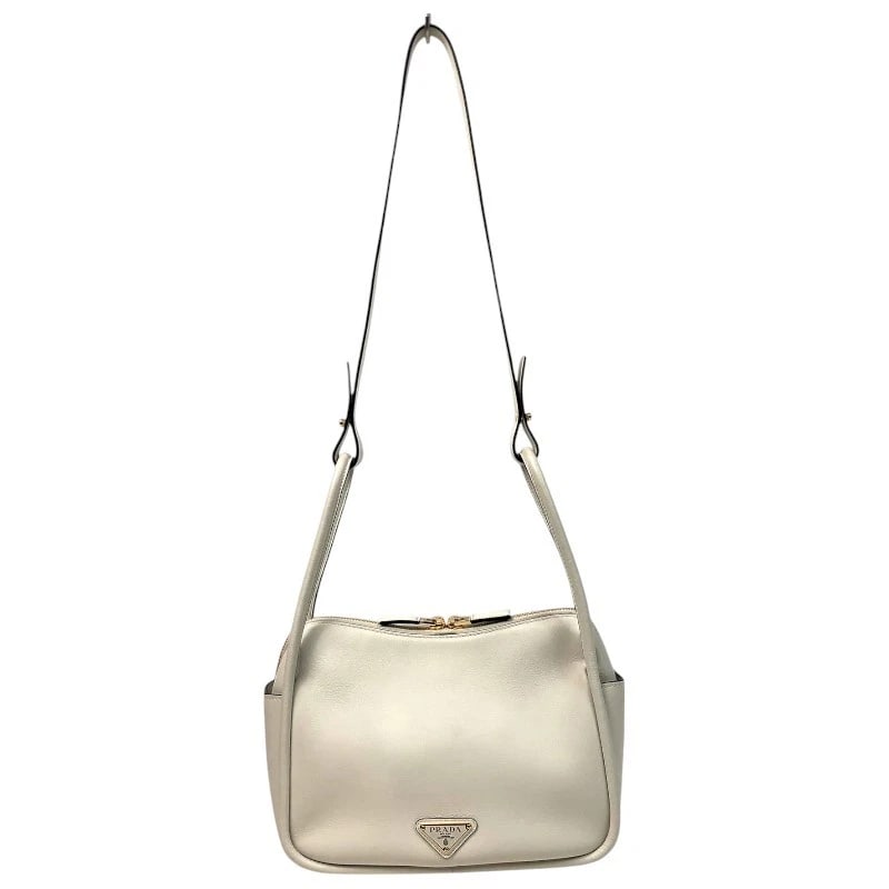 PRADA DARLING HANDBAG HANDBAG: PRADA Darling Handbag Handbag Brand: PRADA Type: Handbag Material: soft grain leather Color: White Gold Hardware Size: W9.8 x H7.5x D3.7inch Shoulder:37.8inch Accessories: None Accessories