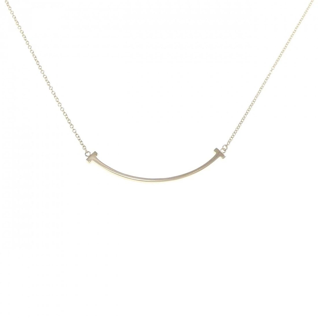 TIFFANY T SMILE SMALL NECKLACE: Tiffany T Smile Small Necklace Brand: Tiffany Type: Necklace Material: 750 Yellow Gold Color: Yellow Gold Size: 40/46cm Accessories: None Accessories Notice: When purchasing pre-owned goods,