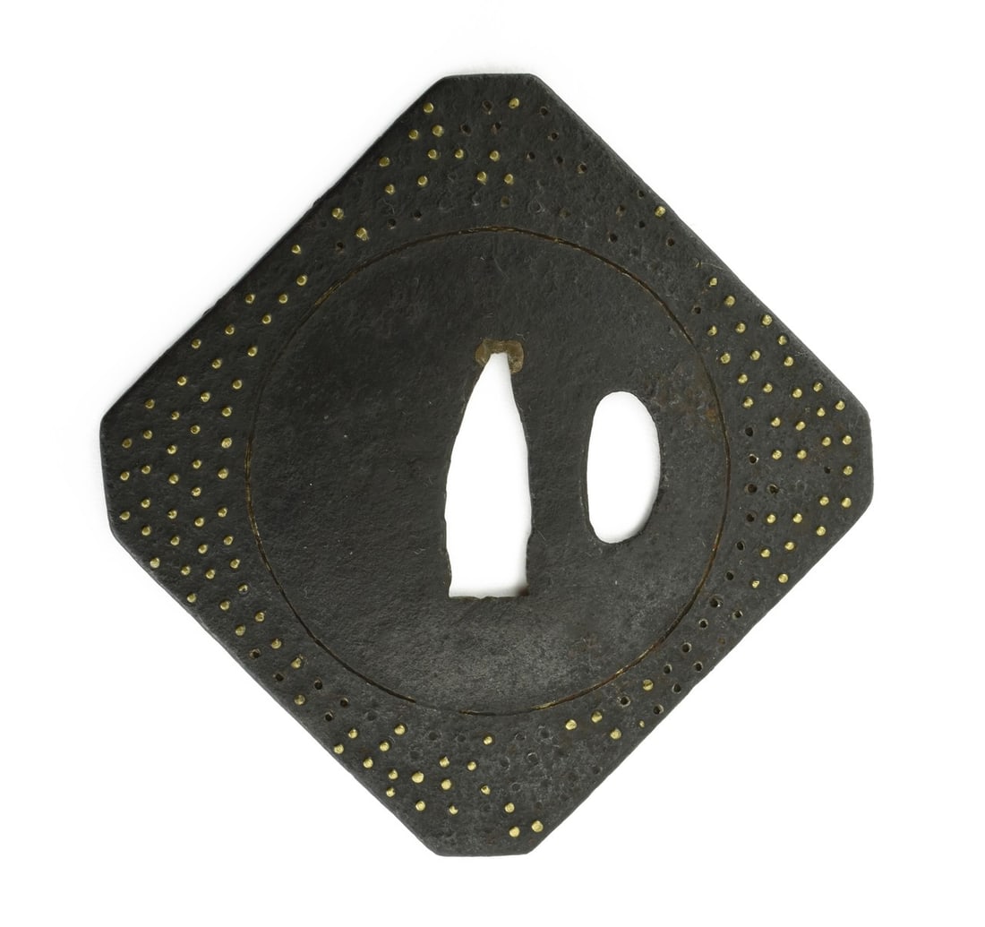 IRON TSUBA: Iron Tsuba Description: Iron Tsuba. Diamond shape. Inlay with brass highlights. Unsigned. Vertical height 3 5/8” (9.2cm.). Boxed. Size: Vertical height 3 5/8” (9.2cm.) Accessories: