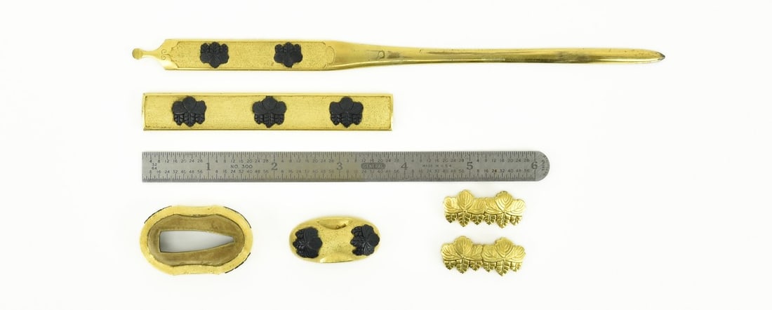 KINKO SET OF KODZUKA, KOGAI, FUCHI KASHIRA, AND MENUKI: Kinko set of Kodzuka, Kogai, Fuchi Kashira, and Menuki (MGJ254) Description: Kinko set of Kodzuka, Kogai, Fuchi Kashira, and Menuki. All in gold with Shakudo Mon. Menuki Mon in gold, Kodzuka,