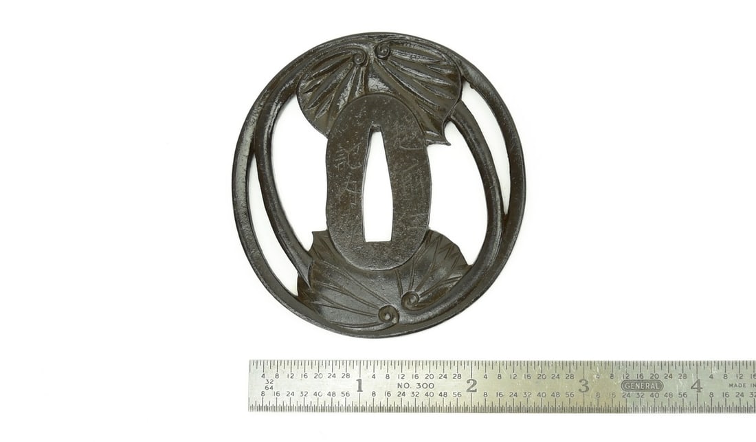 IRON SUKASHI TSUBA: Iron Sukashi Tsuba Description: Iron Sukashi Tsuba. Diameter: 7.1cm, 2 ¾”. Signed: Echizen Ju Kinai Saku. Size: Diameter: 7.1cm, 2 ¾” Accessories: None Accessories Notice: